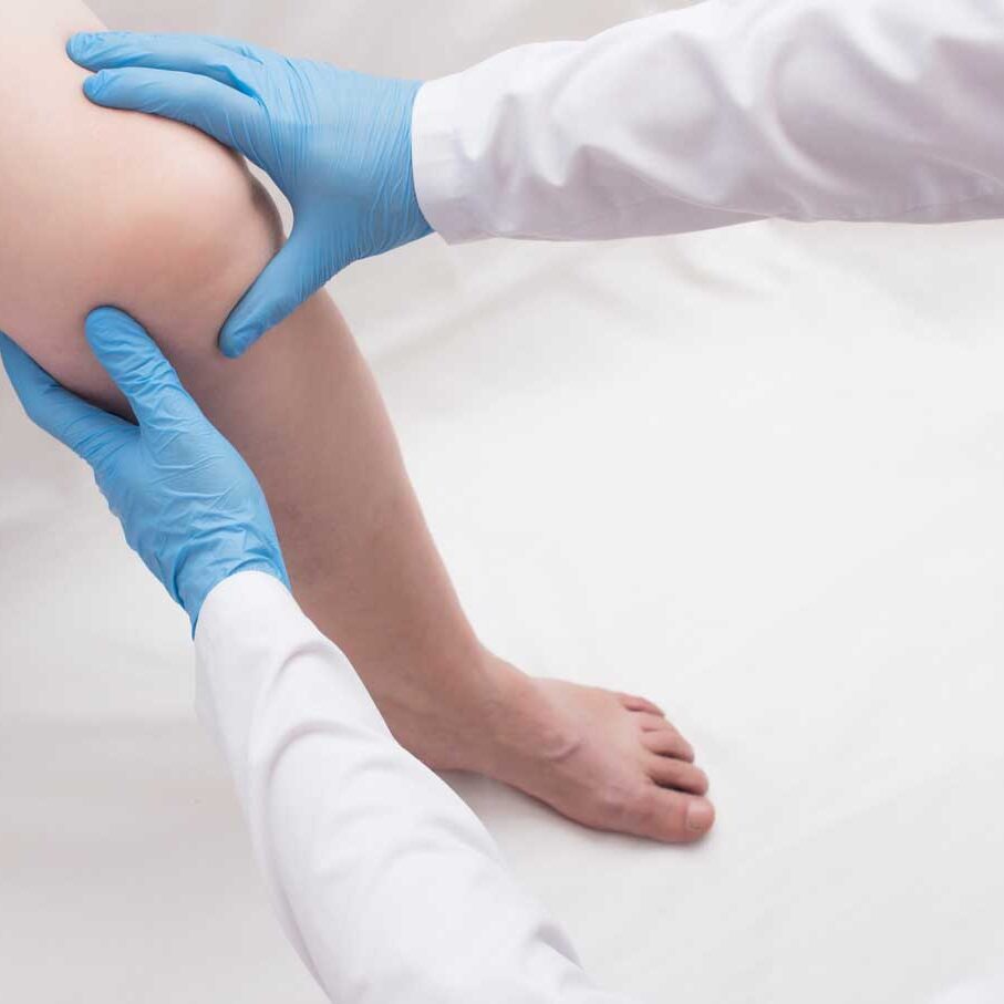 Woman with a sore knee at the doctor's office, examination of the sore knee, patient, copy space Woman with a sore knee at the doctor's office, examination of the sore knee, patient, copy space, inflammation, myofascial syndrome